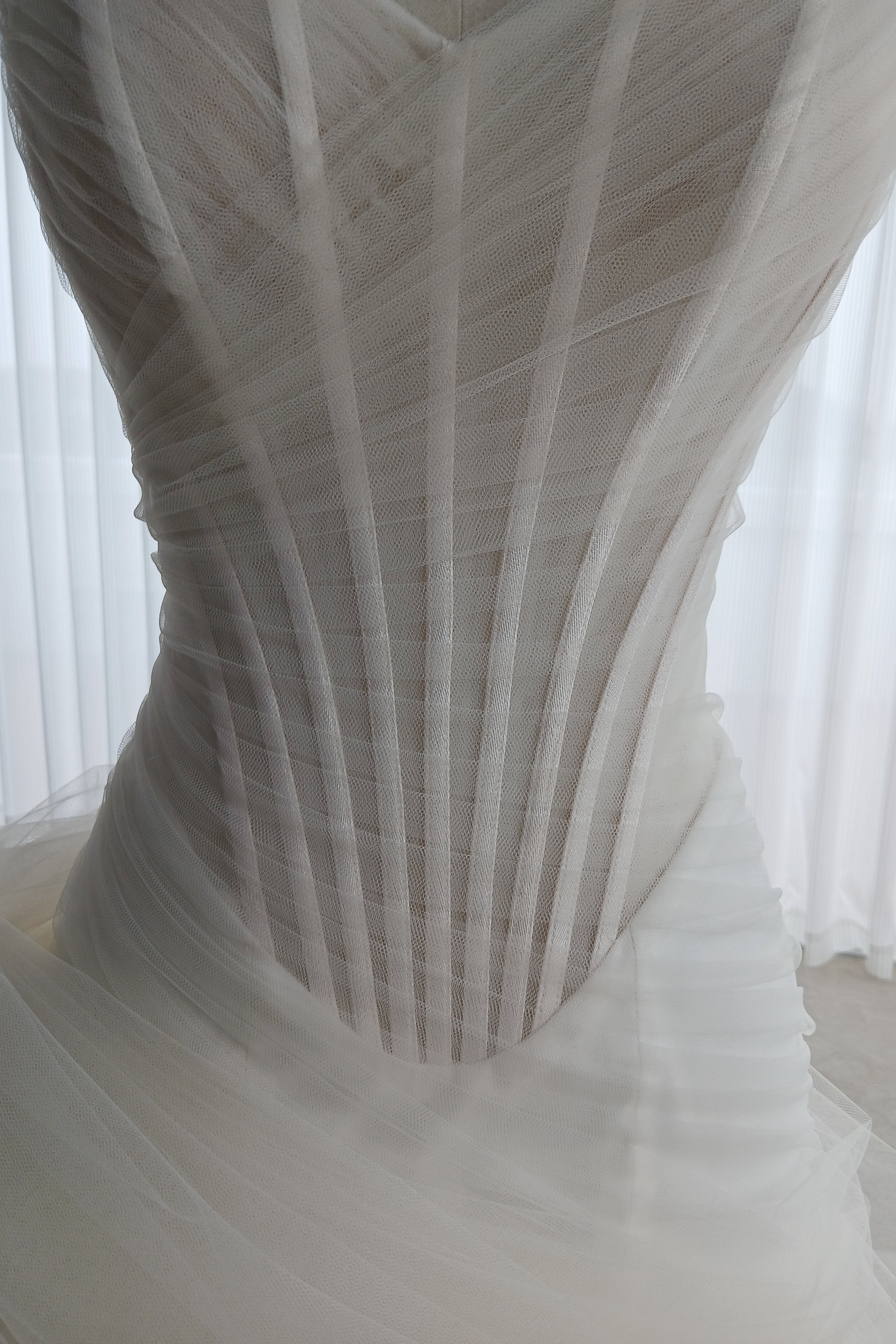 An illusion tulle corset wedding dress with an asymmetric neckline and a flattering mermaid-A-line hybrid skirt LVB2741