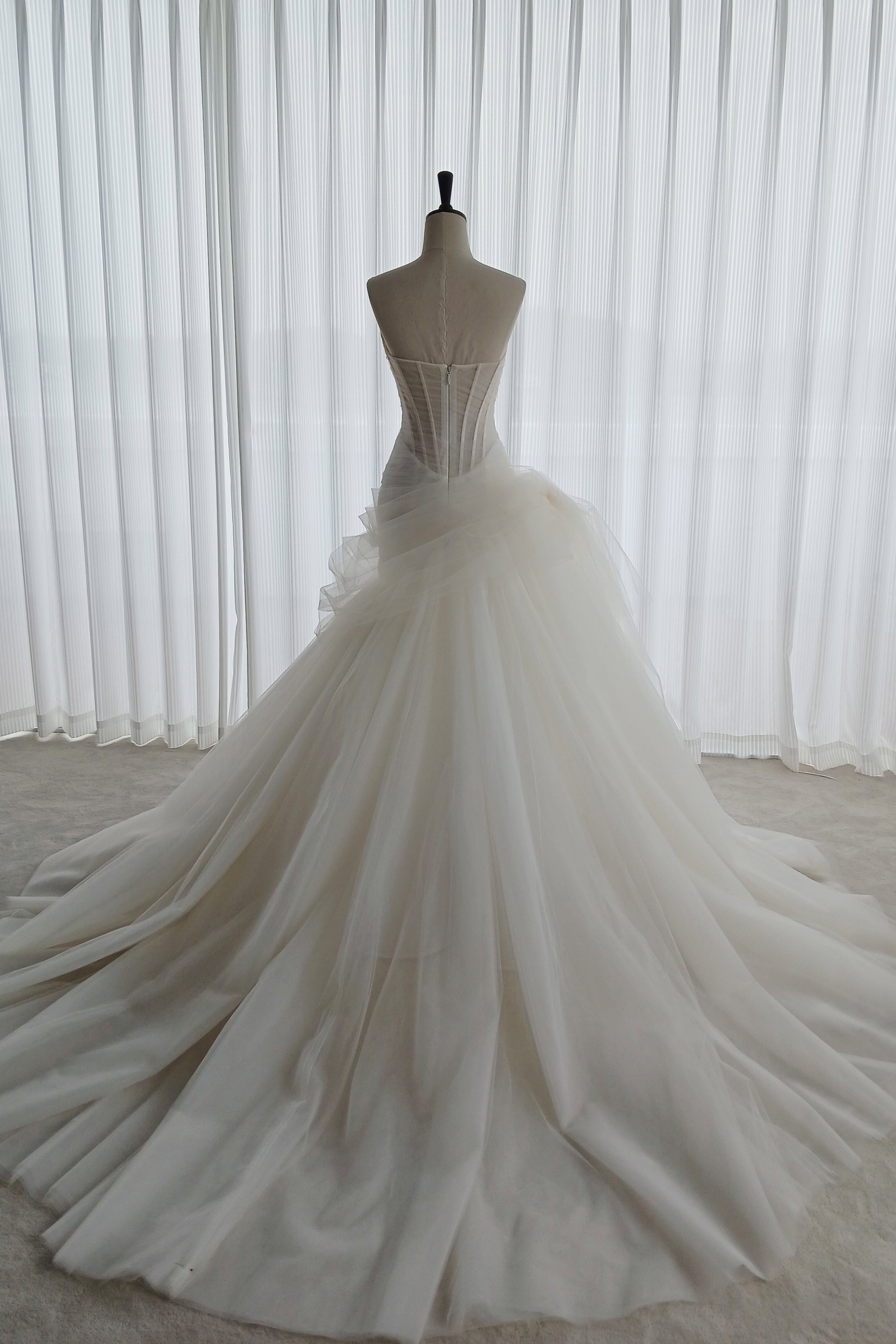 An illusion tulle corset wedding dress with an asymmetric neckline and a flattering mermaid-A-line hybrid skirt LVB2741