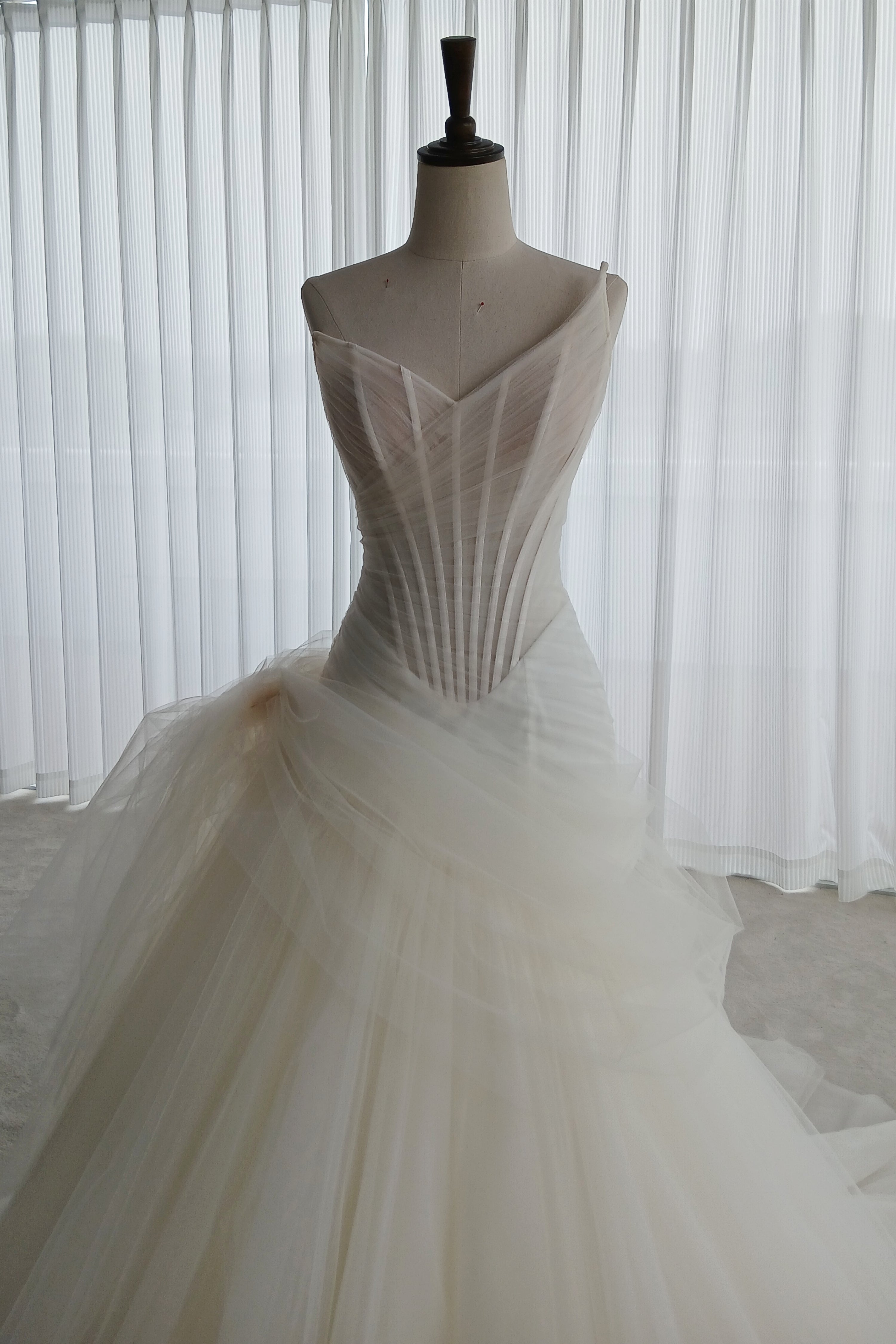 An illusion tulle corset wedding dress with an asymmetric neckline and a flattering mermaid-A-line hybrid skirt LVB2741